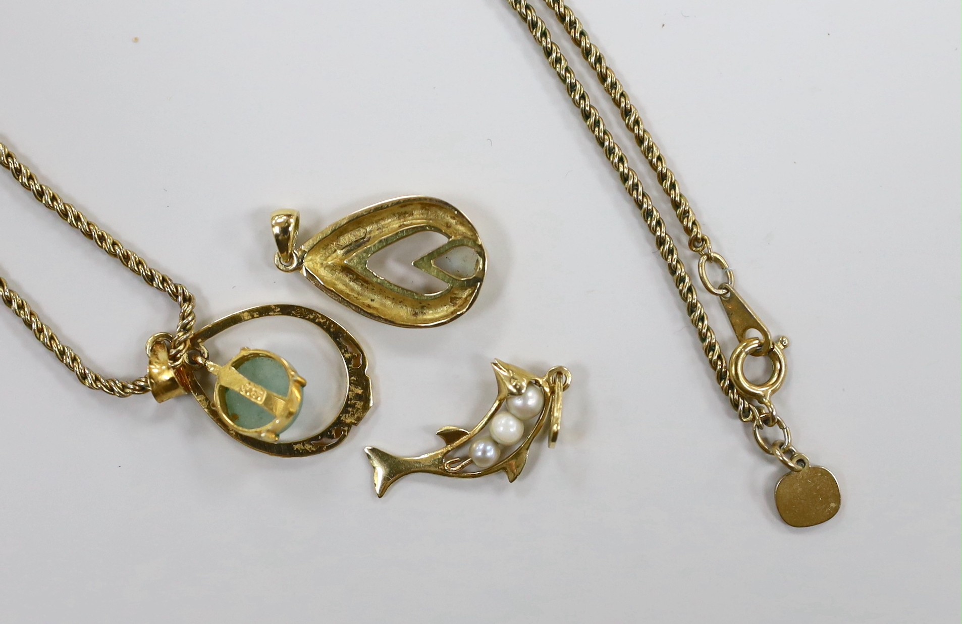 Three modern 18k and gem set small pendants, including cultured pearl set dolphin, overall 28mm and white opal set pear shape, one with gilt metal chain.